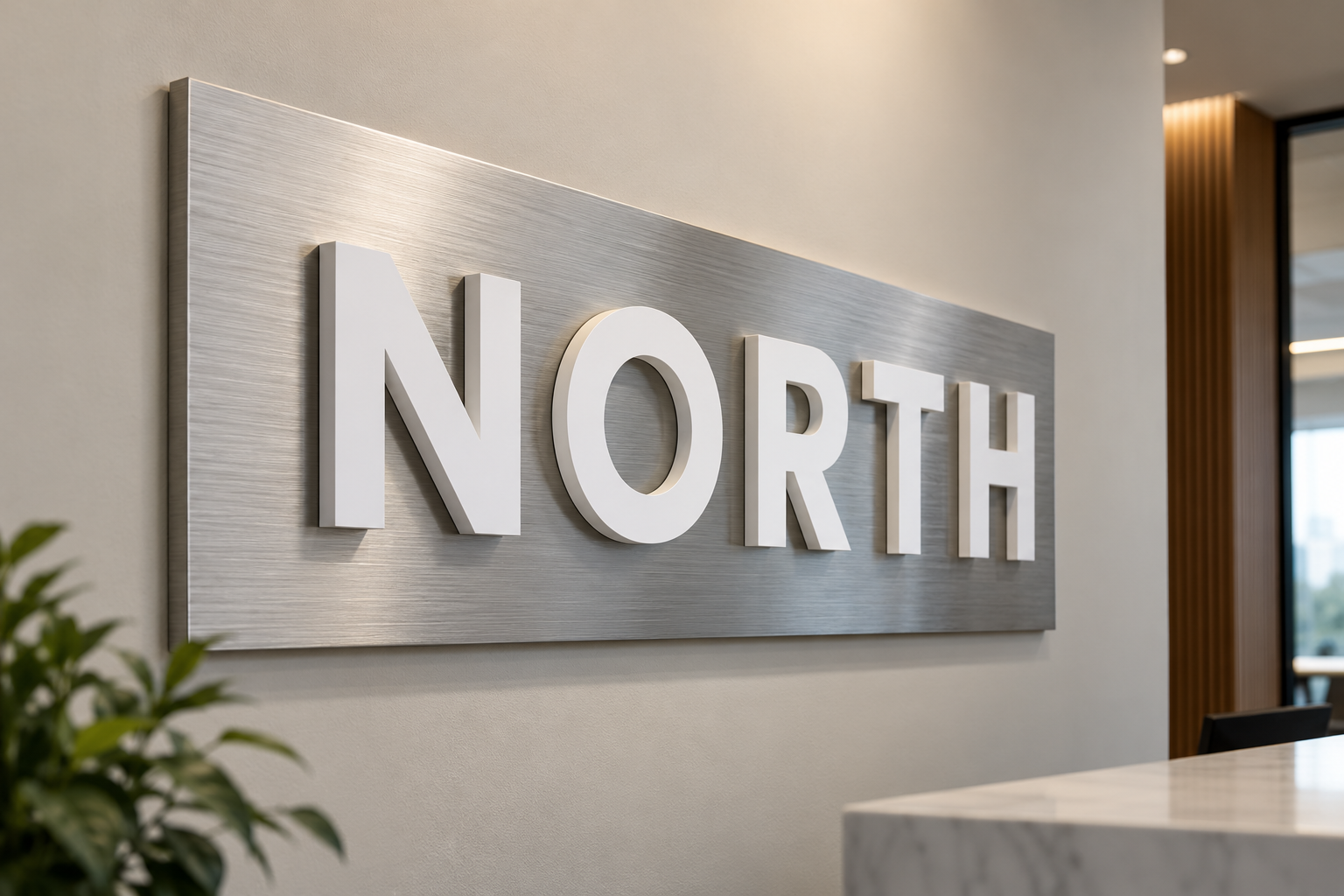 Illustrative example of white Komatex letters mounted over a brushed aluminum panel
